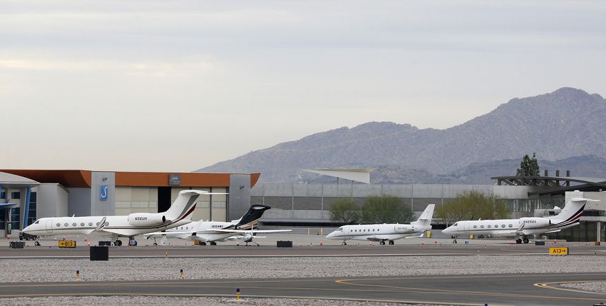 In this Monday, Jan. 26, 2015, photo, private jets are parked at Scottsdale Airport in Scottsdale, Ariz. With the NFL Super Bowl football game and the Phoenix Open PGA golf tournament scheduled this weekend, private jet traffic is expected to increase in the Phoenix area. (AP Photo/Ross D. Franklin)