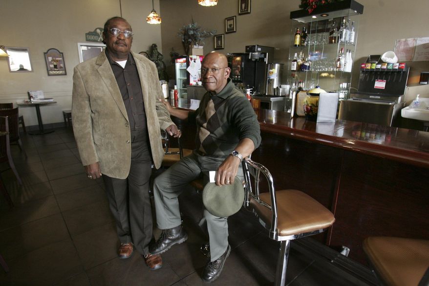FILE - In this March 5, 2009, file photo, the Rev. W. T. "Dub" Massey, right, and Willie McLeod, left, pose at the counter where they were among the "Friendship Nine" who were jailed during 1960s civil rights "sit-ins" at what is now called the Old Town Bistro in Rock Hill, S.C. A prosecutor on Wednesday, Jan. 28, 2015, is expected to ask a judge to vacate the arrests and convictions of the eight Friendship Junior College students and a civil rights organizer. (AP Photo/Mary Ann Chastain, File)