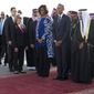 President Barack Obama and first lady Michelle Obama stand with new Saudi King Salman bin Abdul Aziz they arrive on Air Force One at King Khalid International Airport, in Riyadh, Saudi Arabia, Tuesday, Jan. 27, 2015. (AP Photo/Carolyn Kaster)