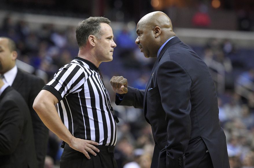 Georgetown head coach John Thompson III, right, talks with an official during a break in the action during the second half of an NCAA college basketball game against Xavier, Tuesday, Jan. 27, 2015, in Washington. Xavier won 66-53. (AP Photo/Nick Wass)