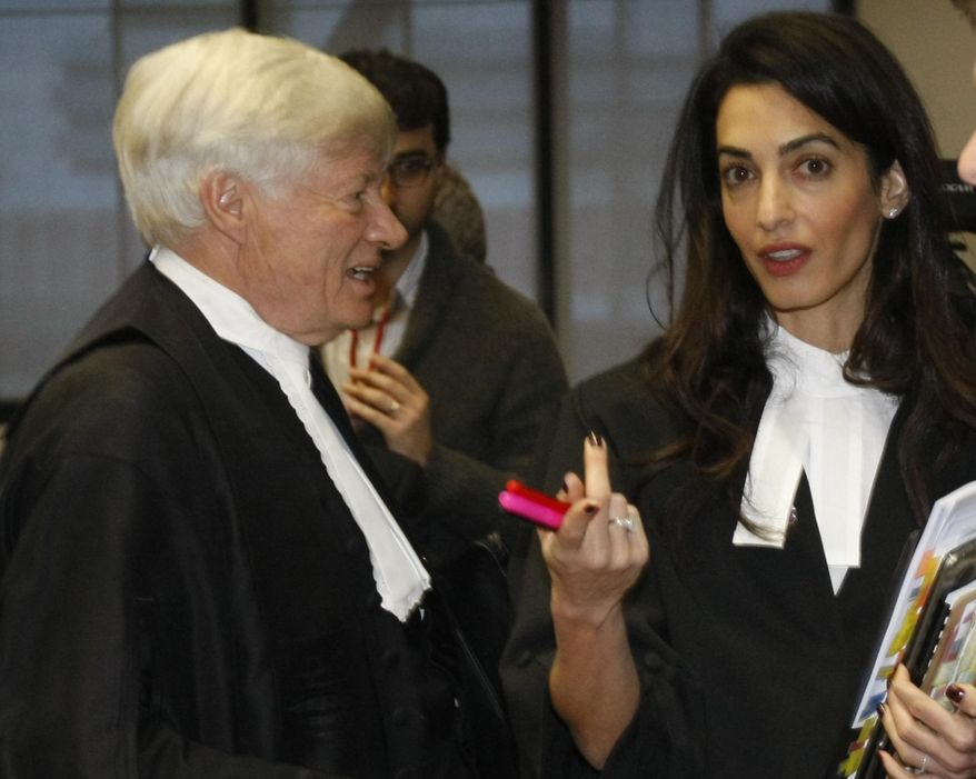 Geoffrey Robertson, left, and Amal Clooney, members of a legal team representing Armenia, arrive at the European Court of Human rights in Strasbourg, eastern France, Wednesday, Jan 28, 2015. Clooney, the wife of George Clooney, is among the lawyers arguing at the European Court of Human Rights against a Turkish man convicted in Switzerland for denying the 1915 Armenian genocide. Armenia, which argues that denying the genocide should be a crime as denying the Holocaust is in many European countries, is challenging a decision that ruled the man’s right to free expression was violated. (AP Photo/Christian Lutz)