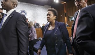 Attorney general nominee Loretta Lynch is escorted by her security detail on Capitol Hill in Washington, Wednesday, Jan. 28, 2015, as the Senate Judiciary Committee takes a break during her confirmation hearing. She is now the U.S. Attorney for the Eastern District of New York. If confirmed, Lynch would replace Attorney General Eric Holder, who announced his resignation in September after leading the Justice Department for six years.  (AP Photo/J. Scott Applewhite)