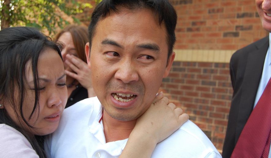 FILE - In this Aug. 5, 2010 file photo, Koua Fong Lee embraces his wife, Panghoua Moua, in St. Paul, Minn., after learning charges him, including criminal vehicular homicide, were dropped. A Minnesota jury hearing a lawsuit against Toyota Motor Corp. will decide whether the automaker is responsible for a fatal crash that killed three people. Lee spent 2½ years in prison for the crash before being released after reports suggested that some Toyota cars had sudden acceleration problems. (AP Photo/Minnesota Public Radio, Tom Weber, File)