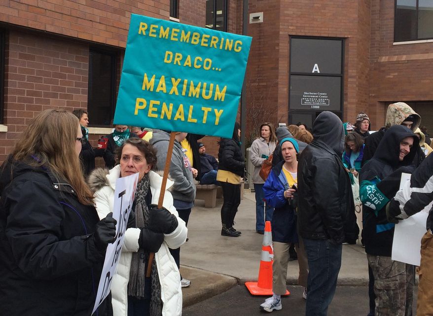 Dozens of protesters rally outside the Sherburne County Courthouse for a Minnesota man accused of videotaping himself as he tortured and killed his girlfriend's dog in Elk River, Minn., Wednesday, Jan. 28, 2015. Anthony Sather made a brief appearance in Sherburne County court Wednesday. Sather faces a felony count of mistreating an animal. (AP Photo/The Star Tribune, Jennifer Brooks) MANDATORY CREDIT; ST. PAUL PIONEER PRESS OUT; MAGS OUT; TWIN CITIES TV OUT