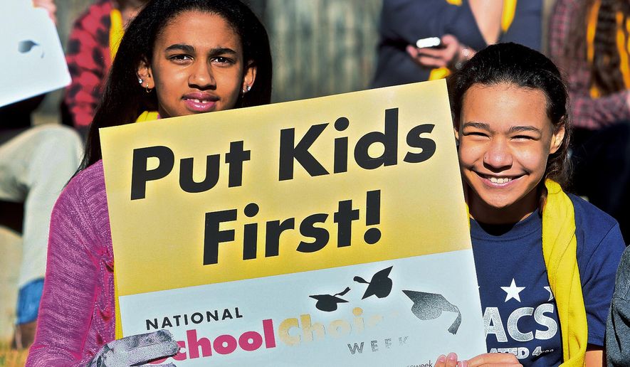 Students Isabel Onisile, 11, left, and Octavia McKindra, 11, attend a rally at the Sierra Nevada Academy Charter School at the National School Choice Week Capitol celebration in Carson City, Nev., on Wednesday, Jan. 28, 2015. An estimated 500 students, parents and teachers, many wearing bright yellow scarves and carrying signs that said &quot;I trust parents&quot; gathered near the Capitol in Carson City on Wednesday to show their support for measures that would make it easier for families to move their children to charter or private schools. (AP Photo/Nevada Appeal, Brad Coman)