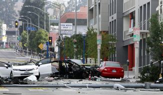 In this photo taken July 4, 2014, a Hollywood street is closed at an accident scene during an investigation after a car crash in West Hollywood, Calif. The chances of dying in a crash in a late-model car or light truck fell by more than a third over three years, and nine car models had zero deaths per million registered vehicles, according to a study by the Insurance Institute for Highway Safety (AP Photo/Richard Vogel)