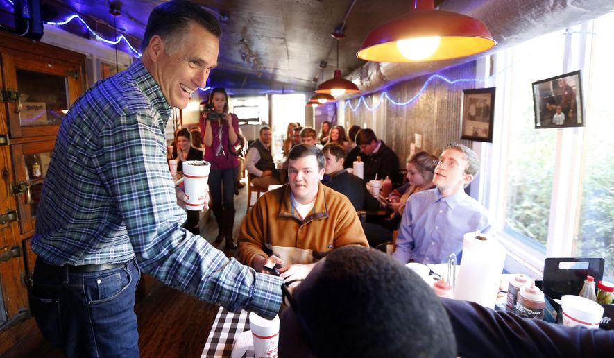 Former GOP presidential candidate Mitt Romney visits with diners at Little Dooey, a barbecue restaurant in Starkville, Miss., Wednesday, Jan. 28, 2015. (AP Photo/Rogelio V. Solis)