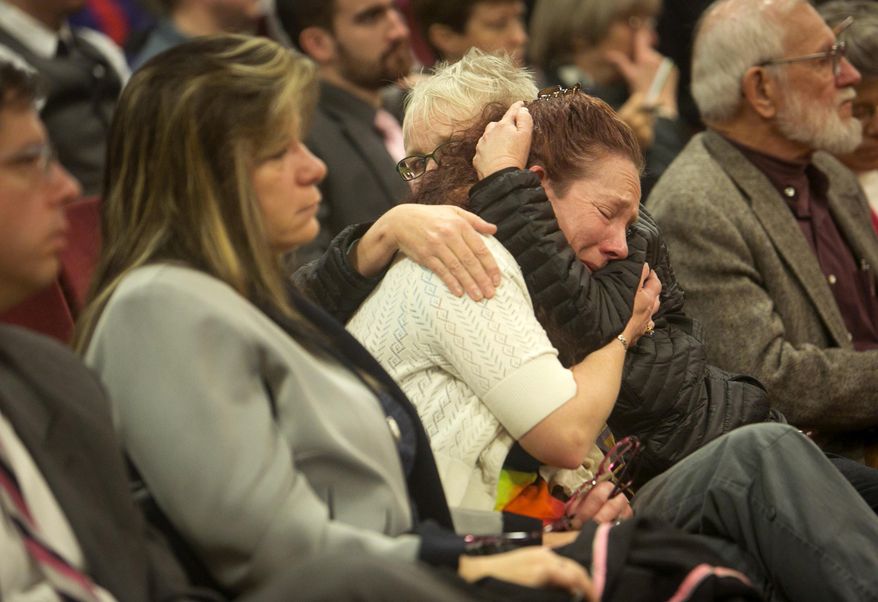 Julie Zicha, center in white, is comforted by Gretchen Bates, in black, as the Idaho House State Affairs committee voted to keep HB2 in committee on Thursday, Jan. 29, 2015. The bill would have added the words sexual orientation and gender identity to the Idaho Human Rights act. "I am representing our children, who can't do it themselves because they aren't here any more," said Zicha, who spoke earlier before the committee about her son, who was gay and committed suicide four years ago. (AP Photo/The Idaho Statesman, Katherine Jones) LOCAL TELEVISION OUT (KTVB 7); MANDATORY CREDIT