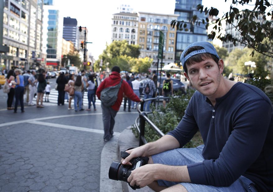 FILE - This Oct. 2, 2013 file photo shows street portrait photographer Brandon Stanton, creator of the popular Humans of New York blog, near Union Square in New York. A fundraising campaign inspired by the popular photo blog has raised more than $1 million to send middle-school students from a high-poverty Brooklyn school on field trips to Harvard. (AP Photo/Kathy Willens)
