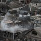 Smoke still rises from a destroyed house that was damaged in Saturday&#39;s shelling in the  Vostochniy district of Mariupol, Ukraine, Monday, Jan. 26, 2015. At least 5,100 people have been killed in eastern Ukraine since fighting began in April 2014, but violence this week was the most intense since a cease-fire deal was signed in September. Mariupol, a strategic port city on the Black Sea still controlled by Ukrainian forces, has been a symbolic bulwark against the separatist advance that if captured by the rebels would give them a land corridor to Russia-controlled Crimea. The city had been relatively quiet for months before Saturday&#39;s attack.(AP Photo/Evgeniy Maloletka)