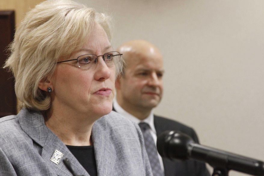 Retired U.S. Army Col. Laurel Hummel, left, speaks after she was named the adjutant general of the Alaska National Guard and commissioner of the Department of Military and Veterans Affairs during a news conference Friday, Jan. 30, 2015, in Anchorage, Alaska. On the right is retired U.S. Air Force Col. Robert Doehl, who will be the new deputy commissioner. (AP Photo/Mark Thiessen)
