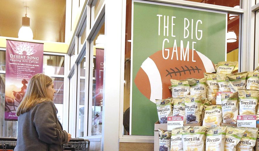 So as not to infringe on the NFL Super Bowl name trademark, all non-rights holders have to use different wording to promote any Super Bowl activity like this Whole Foods grocery store where a customer passes a promotional display for "the big game" Wednesday, Jan. 28, 2015, in Phoenix. (AP Photo/Ross D. Franklin) ** FILE **