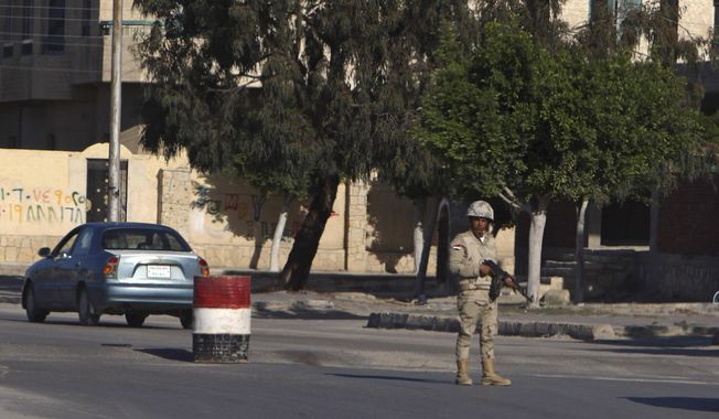 An Egyptian soldier mans a checkpoint in el-Arish, 290 kilometers (180 miles) east of Cairo, North Sinai, Egypt, Saturday, Jan. 31, 2015. Egyptian President Abdel Fattah al-Sissi told the nation in a televised address Saturday to prepare for a long fight to defeat Islamic extremists following a wave of attacks on security forces in the Sinai Peninsula. An Islamic State-linked group in Egypt claimed responsibility for a string of bomb and gun attacks Thursday night targeting Egyptian military positions that killed at least 30 security force members. (AP Photo)