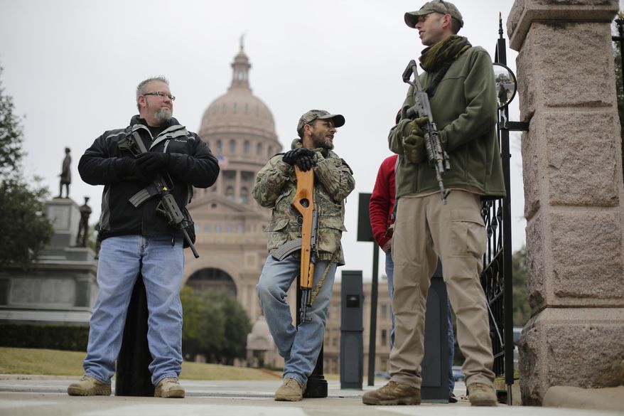 In this Jan. 13, 2015 file photo, gun rights advocates carry rifles while protesting outside the Texas Capitol in Austin. (AP Photo/Eric Gay, File)