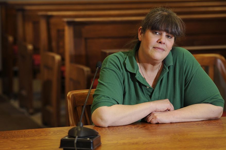 In this photo taken on Thursday, Jan. 15, 2015, Vicki Nicholls of Green Bay poses for a portrait inside the Manitowoc County Courthouse circuit court branch 3 courtroom in Manitowoc, Wis. Nicholls is participating in a program which substitutes traditional punishments with alternative treatments. (AP Photo/Herald Times Reporter, Matthew Apgar)