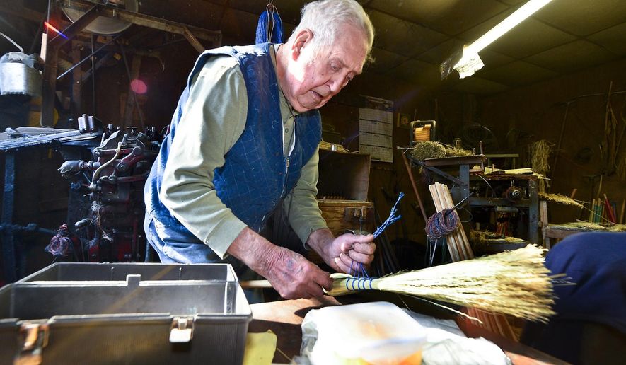 ADVANCED FOR RELEASE SUNDAY, FEBRUARY 1, 2015 AND THEREAFTER Charleston Broom Company owner Jim Shaffer fashions a bundle of corn straw into a broom at his workshop near Kanawha State Forest. Shaffer, 85, has worked for the company for 68 years and became owner in the 1980s. He is one of the only remaining broommakers in West Virginia. (AP Photo/Charleston Daily Mail, Bob Wojcieszak)