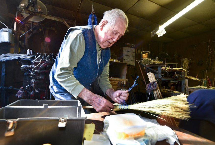 ADVANCED FOR RELEASE SUNDAY, FEBRUARY 1, 2015 AND THEREAFTER Charleston Broom Company owner Jim Shaffer fashions a bundle of corn straw into a broom at his workshop near Kanawha State Forest. Shaffer, 85, has worked for the company for 68 years and became owner in the 1980s. He is one of the only remaining broommakers in West Virginia. (AP Photo/Charleston Daily Mail, Bob Wojcieszak)