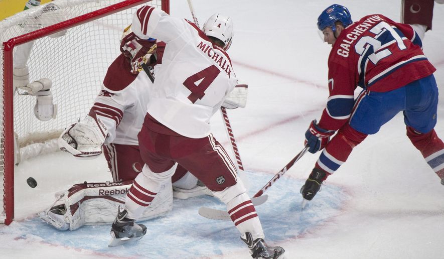 Montreal Canadiens&#39; Alex Galchenyuk, right, scores on Arizona Coyotes goaltender Louis Domingue as Coyotes&#39; Zbynek Michalek (4) defends during first period NHL hockey action in Montreal, Sunday, Feb. 1, 2015. (AP Photo/The Canadian Press, Graham Hughes)