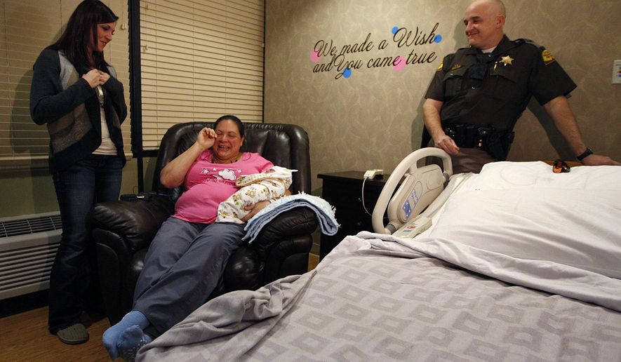 Mariah Ostler meets Brittney Chugg, the 911 dispatcher who answered Ms. Ostler&#39;s call for help when she realized she was about to deliver her baby on the freeway, during a press conference at Brigham City Community Hospital in Brigham City, Utah, Sunday, Feb. 1, 2015. (AP Photo/The Deseret News, Chelsey Allder)