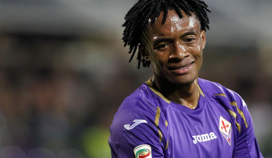 In this Sept. 24, 2014 file photo, Fiorentina&#39;s Juan Cuadrado reacts during a Serie A soccer match between Fiorentina and Sassuolo at the Artemio Franchi stadium in Florence. Fiorentina coach Vincenzo Montella has confirmed Friday, Jan. 30, 2015, Juan Cuadrado is set to complete a move to Chelsea, with Mohamed Salah moving on loan in the opposite direction. Cuadrado is expected to undergo a medical in London on Saturday ahead of signing a permanent deal with the Premier League club. (AP Photo/Fabrizio Giovannozzi, file)