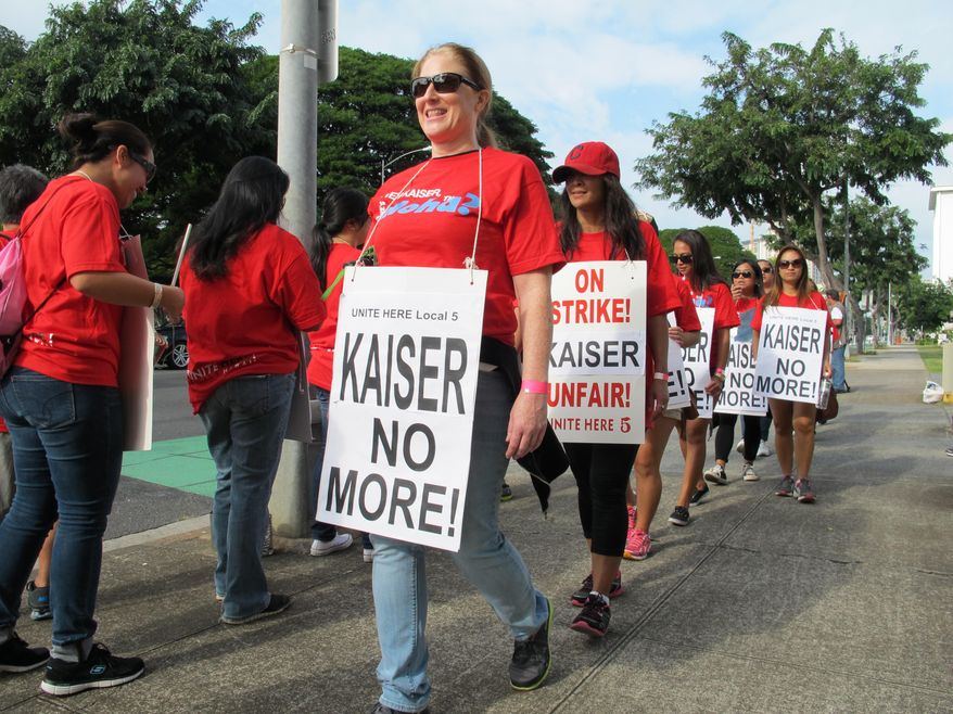 Kaiser Permanente employees picket Kaiser's Honolulu clinic on Monday, Feb. 2, 2015. The workers, members of the Unite Here Local 5 union, started a six-day strike on Monday in objection to what the union calls a low proposed wage increase and a proposal to eliminate guaranteed pensions for new employees. (AP Photo/Audrey McAvoy)