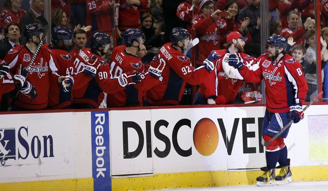 Washington Capitals left wing Alex Ovechkin (8), from Russia, celebrates his goal in the second period of an NHL hockey game against the St. Louis Blues, Sunday, Feb. 1, 2015, in Washington. (AP Photo/Alex Brandon)