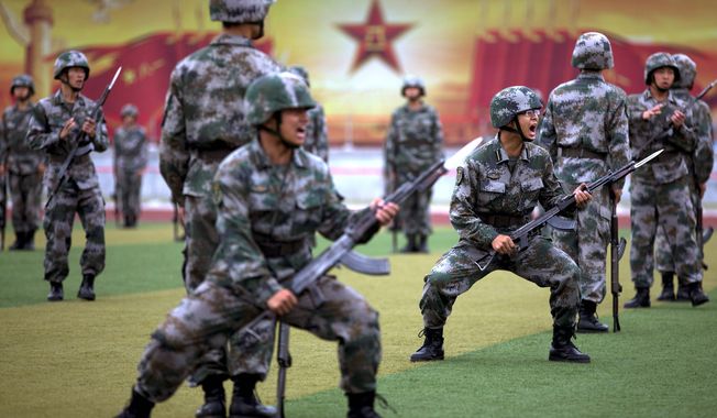 Chinese People’s Liberation Army cadets take part in a bayonet drills at the PLA’s Armoured Forces Engineering Academy Base, on the outskirts of Beijing. (Associated Press)