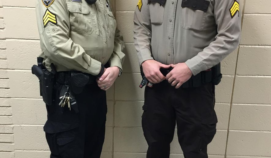 In this photo provided by the Sublette County Sheriff&#39;s Office, Detention Sergeant Travis Bingham, left and Patrol Sergeant Rich Kaumo pose in two of the different uniforms previously utilized by the Sublette County Sheriff at the Sheriff’s Office on Monday, Feb. 2, 2015, in Pinedale, Wyo. The new sheriff of a Wyoming county has banned his deputies from wearing cowboy hats and cowboy boots, a change that led one longtime deputy to retire rather than give up his Western attire. Sublette County Sheriff Stephen Haskell imposed the new dress code in the western Wyoming county that includes Pinedale, which True West magazine recently named a true Western town.  (AP Photo/Sublette County Sheriff&#39;s Office, Sgt. Katherine A. Peterson)