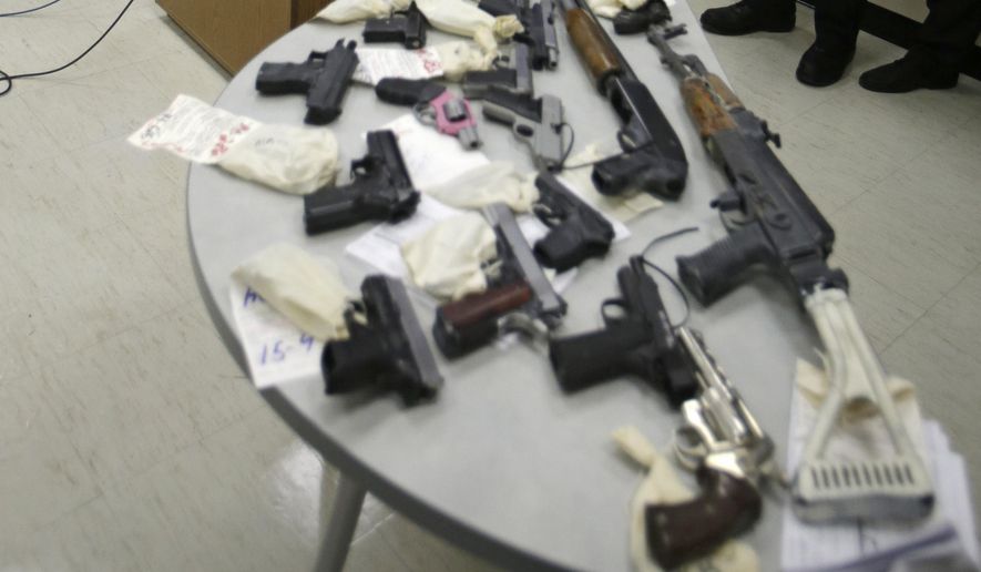 Cuyahoga County Prosecutor Timothy J. McGinty answers questions during a news conference, Monday, Feb. 2, 2015 in front of a table full of guns taken from gang members in Cleveland. (AP Photo/Tony Dejak) ** FILE **