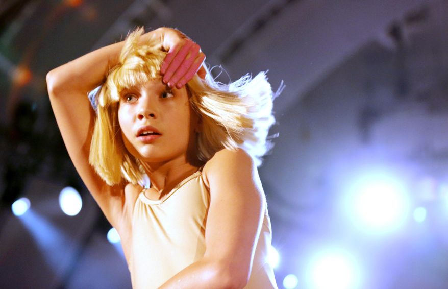 FILE - In this Oct. 24, 2014 file photo, Maddie Ziegler dances to Sia's performance at CBS Radio's second annual We Can Survive concert at the Hollywood Bowl in Los Angeles. The face for Sia’s music – the child dancer Ziegler who first gained fame as a star on the Lifetime series, “Dance Moms” – says singing could be in her future. (Photo by Todd Williamson/Invision/AP, File)