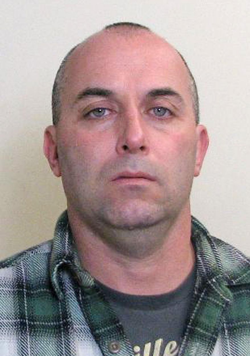 This undated photo provided by the Madison County Sheriff's Department shows Edwardsville police officer Brian Barker in a booking mug. The southwestern Illinois police officer already accused of conducting burglaries while on duty faces new charges alleging he carried out more break-ins and set fire to a building that housed a state lawmaker's office. The nine new felonies filed Monday, Feb. 2, 2015 against Barker, include an arson count linked to the November 2013 fire that damaged the Edwardsville office of Republican Illinois state Rep. Dwight Kay.(AP Photo/Madison County Sheriff's Department)