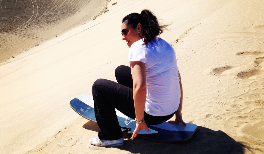 Lea Hutchins, who writes The Lone Traveler blog for The Washington Times, in the Middle East -- where she attempted to sand sled and sand board.