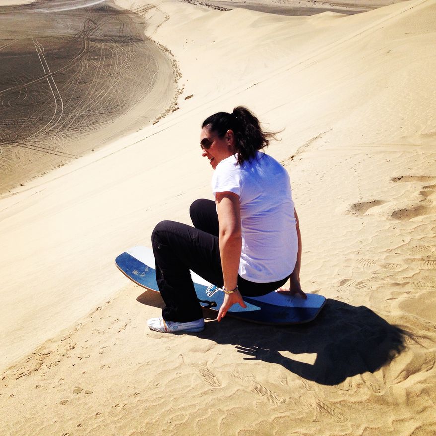 Lea Hutchins, who writes The Lone Traveler blog for The Washington Times, in the Middle East -- where she attempted to sand sled and sand board.