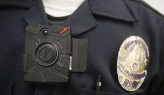 FILE - This Jan. 15, 2014, file photo, a Los Angeles Police officer wears an on-body cameras during a demonstration for media in Los Angeles. A small number of Cleveland patrol officers will take to the streets Wednesday, Feb. 4, 2015, equipped with new city-owned body cameras, technology that officials hope will provide more accountability within the troubled department and close the gap of mistrust of police within the community. Cleveland joins a growing roster of big cities that equip officers with body cameras, including Los Angeles, which announced a plan in December to provide them to 7,000 officers. (AP Photo/Damian Dovarganes, File)