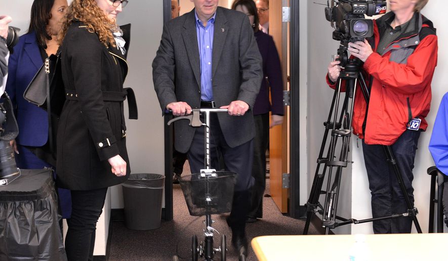FILE- In this Jan. 26, 2015 file photo, Michigan Gov. Rick Snyder, who has an injured ankle, arrives on his scooter before he addresses the state's Civil Rights Commission in Lansing, Mich. The governor has been hospitalized with a blood clot in his right leg, about a month after tearing his Achilles tendon while jogging. Snyder spokeswoman Sara Wurfel says the 56-year-old governor was admitted to St. Joseph Mercy Hospital near Ann Arbor late Thursday, Feb. 5. The governor had noticed swelling in his leg, and doctors determined it was a blood clot. (AP Photo/Detroit News, Dale G. Young, FILE) DETROIT FREE PRESS OUT; HUFFINGTON POST OUT