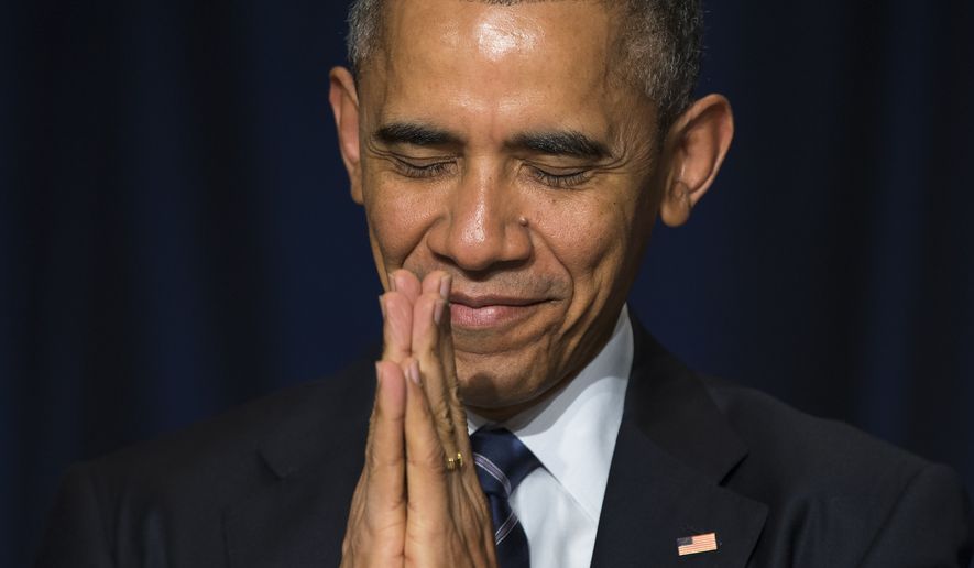 President Barack Obama bows his head towards the Dalai Lama as he was recognized during the National Prayer Breakfast in Washington, Thursday, Feb. 5, 2015.  The annual event brings together U.S. and international leaders from different parties and religions for an hour devoted to faith. (AP Photo/Evan Vucci)