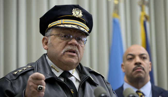 Philadelphia Police Commissioner Charles Ramsey, left, speaks as District Attorney Seth Williams listens during a news conference Thursday, Feb. 5, 2015, in Philadelphia. Two Philadelphia police officers face brutality charges after prosecutors say they knocked a man off a scooter and beat him so severely another officer thought the bloodied man had been shot. (AP Photo/Matt Rourke)