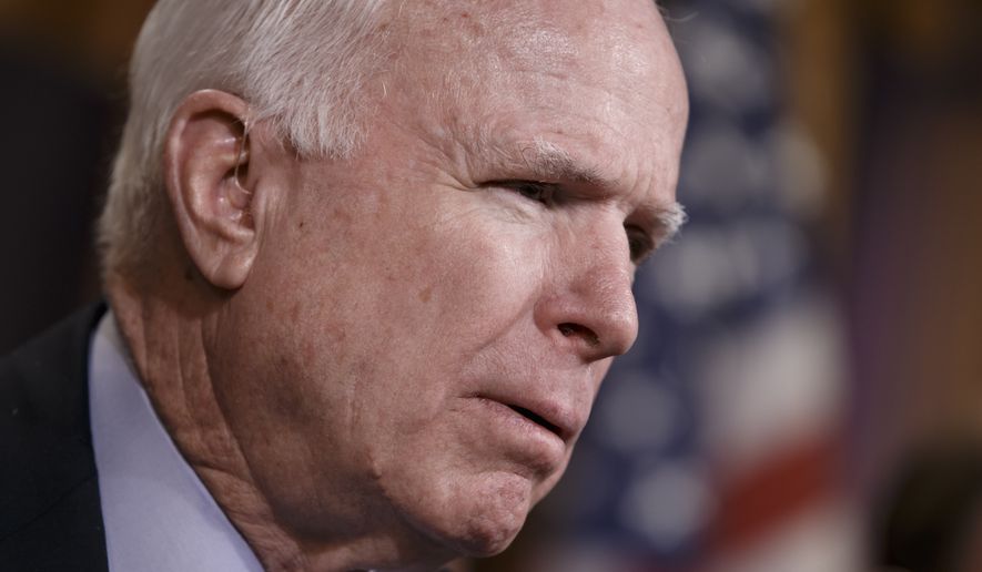 Senate Armed Services Committee Chairman John McCain, R-Ariz., gathers a bipartisan group of senators to call on President Barack Obama to provide defensive weapons to Ukraine to fight Russian-backed rebel groups and to stave off incursions from Russia and Ukrainian separatists, during a news conference on Capitol Hill in Washington, Thursday, Feb. 5, 2015. (AP Photo/J. Scott Applewhite)