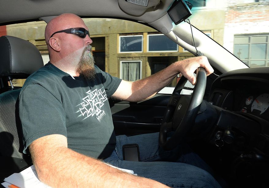 ADVANCE FOR FRIDAY FEB. 6 AND THEREAFTER - In a Jan. 27, 2015 photo, Ken Jeanneret drives his Dodge truck to repo a Dodge Neon at a residence in St. Joseph, Mo. Jeanneret owns and operates SYR (Store Your Ride) Association, a North Kansas City repossession business. (AP Photo/The St. Joseph News-Press, Andrew Carpenean)