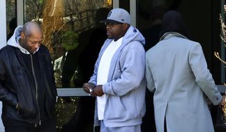 Entertainer Bobby Brown, center, stands outside of Emory Hospital in Atlanta where his daughter Bobbi Kristina Brown is being treated, Thursday, Feb. 5, 2015. Bobbi Kristina Brown, the only child of Bobby and the late Whitney Houston, has been hospitalized since Jan. 31 after being found unresponsive in a bathtub at a suburban Atlanta home. (AP Photo/Ron Harris)