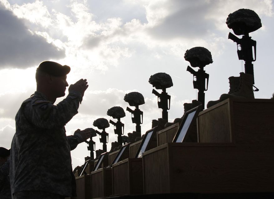 In this Nov. 10, 2009, photo, soldiers salute as they honor victims of the Fort Hood shooting at a memorial service at Fort Hood, Texas. The Army said in a letter addressed to Congress on Friday, Feb. 6, 2015 that the victims of the 2009 shooting that left 13 dead and more than 30 wounded will receive the Purple Hearts many have said they deserve. (AP Photo/Donna McWilliam) **FILE**