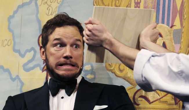 Actor Chris Pratt gets ready to break a board with his head during a roast at Harvard University, in Cambridge, Mass., Friday, Feb. 6, 2015. (Associated Press) ** FILE **