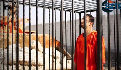This still image made from video released by Islamic State group militants and posted on the website of the SITE Intelligence Group in this Tuesday, Feb. 3, 2015, file photo, shows Jordanian pilot Lt. Muath al-Kaseasbeh standing in a cage just before being burned to death by his captors. (AP Photo/SITE Intelligence Group, File)