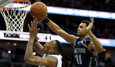 Seton Hall forward Brandon Mobley, left, goes up for a shot against Georgetown forward Isaac Copeland during the second half of an NCAA college basketball game, Tuesday, Feb. 10, 2015, in Newark, N.J. Georgetown won 86-67.  (AP Photo/Julio Cortez)