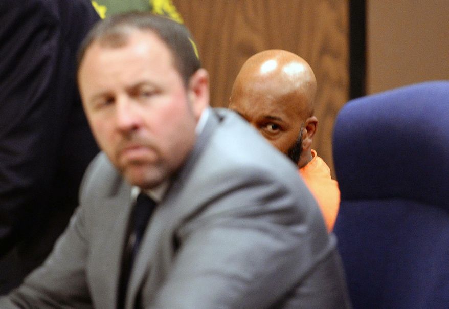 Marion "Suge" Knight, right, is joined by his attorney Brett Greenfield, left, during a hearing at the Compton Courthouse in Compton, Calif. on Monday, Feb. 9, 2015. A judge says former rap mogul Knight should stay behind bars until his next court hearing in March, related to a deadly hit-and-run. A prosecutor and Knight's attorney asked for a delay in a bail-review hearing Monday, with both sides stating they needed more time to prepare. (AP Photo/Robyn Beck, Pool)