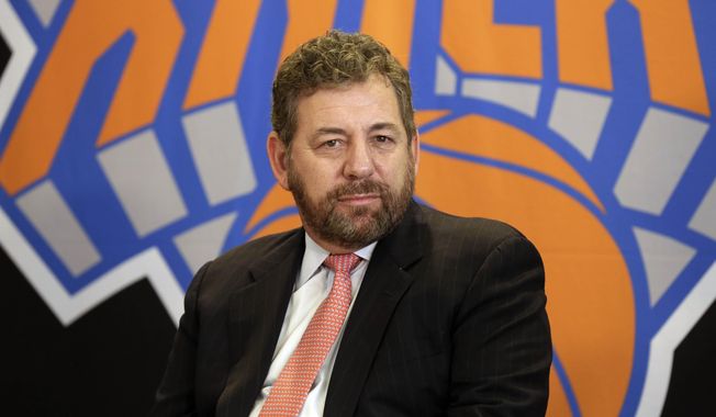 In this March 18, 2014, file photo,  New York Knicks owner James Dolan listens to a question during a news conference in New York. He is the owner many Knicks fans love to hate, the guy they blame for the team&#x27;s failings. He&#x27;s also a wildly successful businessman bringing in money for his companies and leagues. So James Dolan isn&#x27;t going anywhere.  (AP Photo/Richard Drew, File)