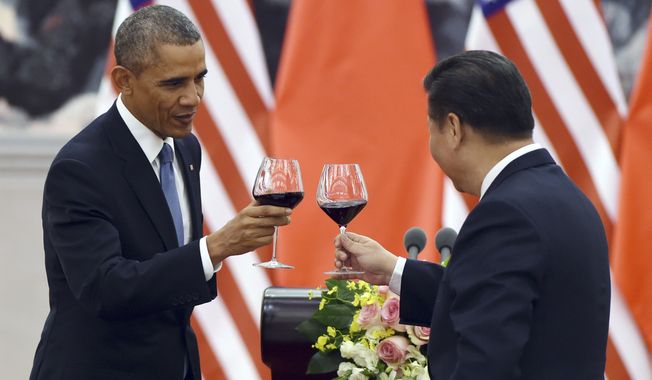 President Barack Obama, left, toasts with Chinese President Xi Jinping on Nov. 12 at a lunch banquet in the Great Hall of the People in Beijing. China has become one of the world&#x27;s largest two economies, and is wealthy enough to buy up at least $1.3 trillion of the U.S. debt. But that hasn&#x27;t stopped Uncle Sam from continuing to send foreign aid to Beijing. (Associated Press)