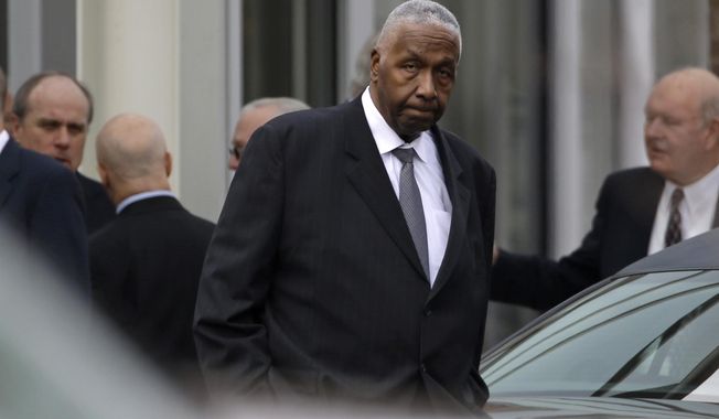 Sports commentator and former Georgetown University basketball coach John Thompson leaves following a private church service for former North Carolina basketball coach Dean Smith in Chapel Hill, N.C., Thursday, Feb. 12, 2015. Smith died Saturday, Feb. 7, 2015. (AP Photo/Gerry Broome)