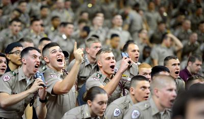 Members of the Texas A&amp;M University Corps of Cadets take selfies as they are features on big screen at at Reed Arena in College Station, Texas on Wednesday, Feb. 11, 2015, during the first half of a NCAA college basketball game between Georgia and Texas A&amp;M. Georgia won 62-53. (AP Photo/College Station Eagle, Sam Craft)