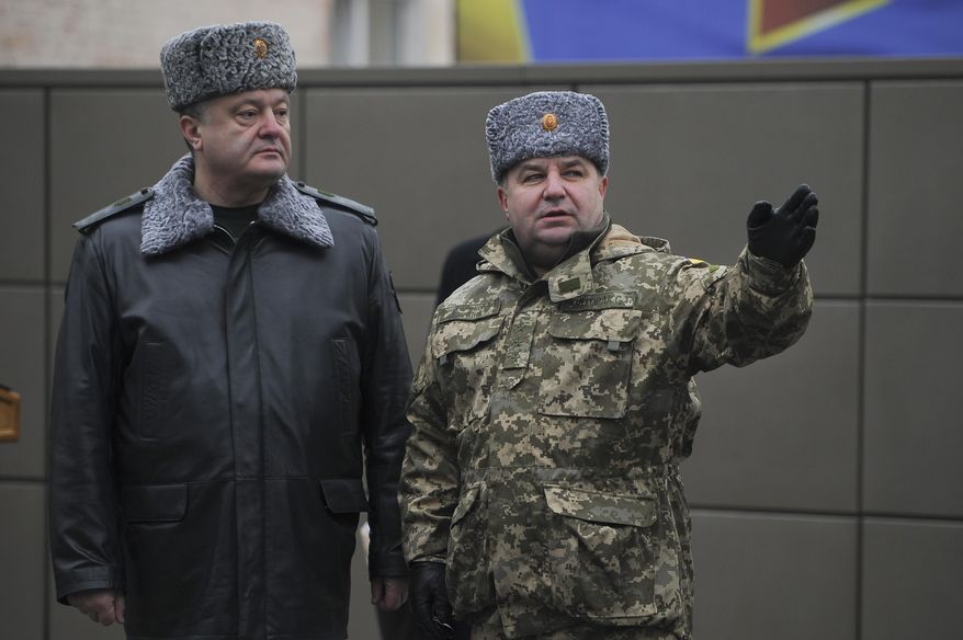 Ukraine's President Petro Poroshenko, left, and defence minister Stepan Poltorak, talk at the National Guard Training Center in Novy Petrivtsy, Ukraine, Friday, Feb. 13, 2015. (AP Photo/ Andrew Kravchenko, Pool)